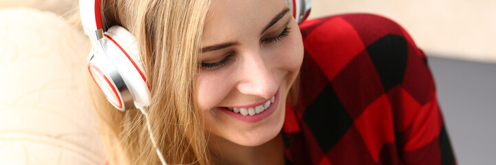blond young pretty woman listen music headphones dream relax concept