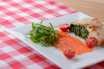 Carpaccio of salmon with cherry tomatoes in restaurant