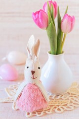 Fototapeta na wymiar beautiful easter table decoration with eggs ,rabbits and flowers in pastel colors