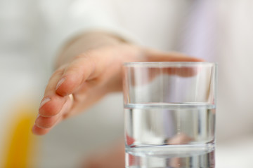 Male arm stretching out to glass in office closeup