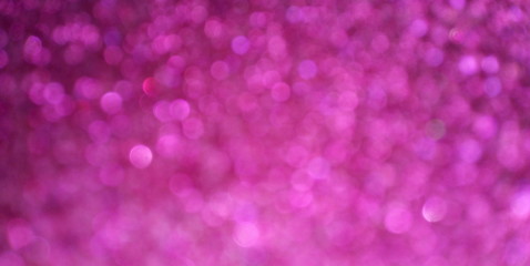 Festive background with blurry bokeh lights Pink and burgundy shiny confetti