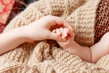Newborn children's hand in brother hand. Happy Family concept.