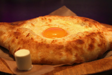 traditional adjarian georgian and armenian cuisine, khachapuri with suluguni cheese and egg yolk