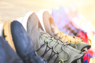 Sneakers stand in a line for sale second hand shoes or wash shoes dry / Canvas Shoes