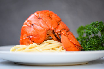 Spaghetti seafood lobster food on a white plate - spaghetti shrimp dinner with herb spices lemon served table in the restaurant gourmet food healthy boiled lobster tail cooked
