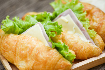 Croissant sandwiches on wooden table - Close up croissant salad ham vegetable