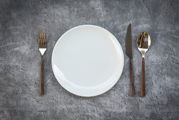 Place setting table food with set of white plate on table cloths or napkin on the dinner / empty...