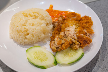 Chinese styled fried chicken meat rice served with chili sauce