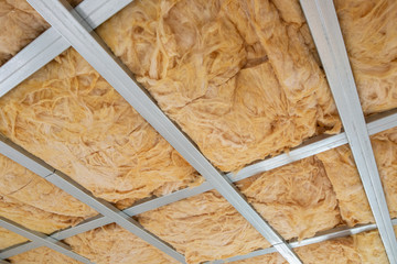 Glass wool on the roof of the new house, ready for plasterboard, industrial concept