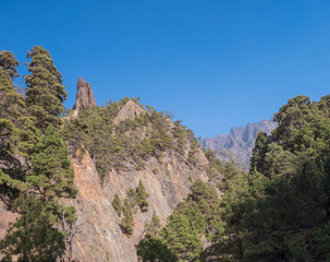 Fototapeta na wymiar View on Roque Idafe, rock formation at ravine of the Barranco de las Angustias canyon at hiking trail Caldera de Taburiente, La Palma, Canary Islands, Spain