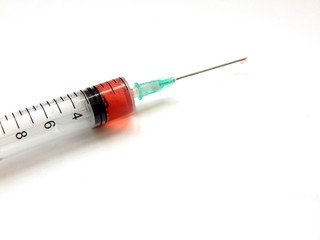 Fototapeta premium Part of a syringe with medication, needle, close-up on a white background