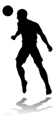 A soccer or football player in silhouette
