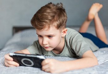child plays on the console, gambling addiction and problem gambling, parenting and development of...