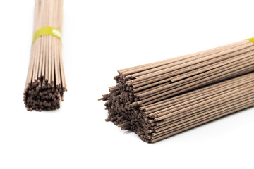 Dried raw japanese soba noodle sticks isolated on a white background. - Image
