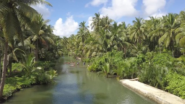 Siargao Island, Philippines - January 2020: Aerial of people on a Maasin River close to the secret palm tree swing in Siargao