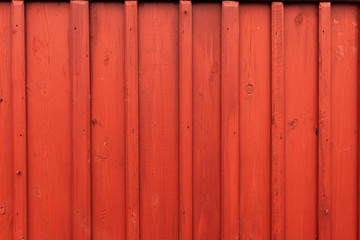 Red wooden wall of a Norwegian cabin or barn