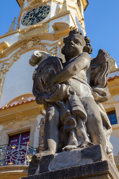 PRAGUE, CZECH REPUBLIC - OCTOBER 14, 2018: The baroque angel before facade of Loreto church  - designed by Kilian Ignac (1772).