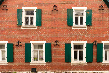 Brick wall and green shutters