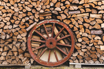 Wood stack with a red wheel