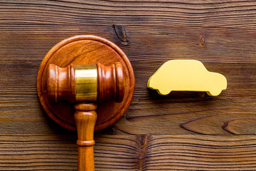 Car credit debt concept with judge gavel on dark wooden background top-down