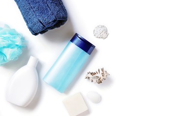 Flat lay beauty photography. Blue sponge, white shampoo bottle package, natural shower gel. Organic bath products, spa cosmetics for skin, hair care 