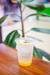 Honey lemon drink on the cafe table background