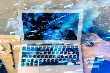 Double exposure of desktop computer and technology theme hologram. Concept of software development.