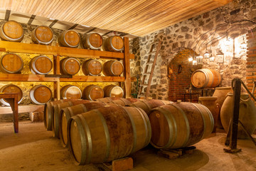 oak wine barrels in basement of winery
