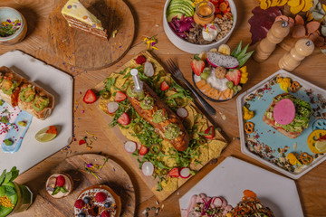 Varied plates of healthy organic food on wooden table. Healthy food concept. Brunch.