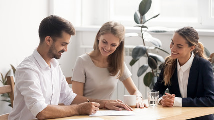 Smiling businessman signing contract, making legal deal with partners