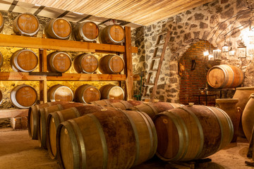 oak wine barrels in basement of winery