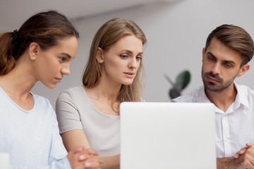 Serious businesswoman mentor training staff, explaining online project