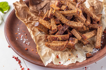 Rye bread croutons on a plate, appetizer for salads, soups or beer, Closeup