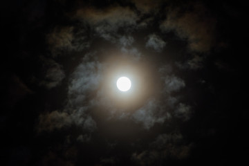 Naklejka na ściany i meble Moon on in the night sky among clouds; natural background of the night sky with the moon
