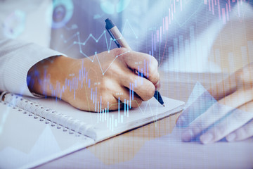 Multi exposure of man planing investment with stock market forex chart.