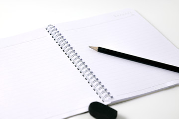 notebook and pencill on white background