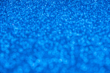 Blue glitter in defocus. Blurred background, stylish abstraction