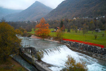 Mountain river and little hydroelectric power station in Alps
