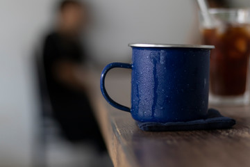 cup of coffee metal blue cup in a coffee shop
