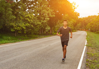  Young black runner man running on the street be exercise and workout in nature countryside road in the morning. Healthy body exercise sports concept.