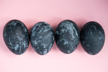 Background with easter eggs. Naturally dyed eggs prepared for Easter on pink background. Happy Easter card. 