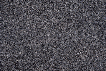 Black rubber crumb surface background.