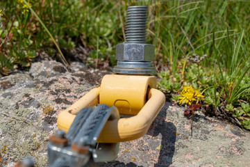 Anchor in rock holding a metall rope. Mounting metall rope to the rock.