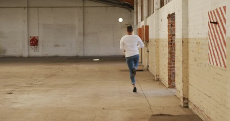 Male dancer in an empty warehouse - Powered by Adobe