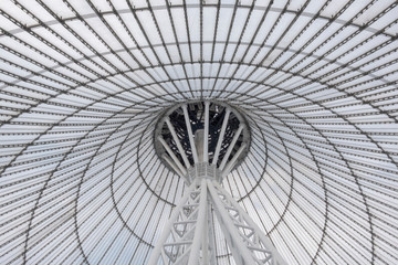 Giant metall colums holding a top of giant conic roof construction. Frame of unusual roof construction.