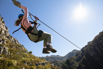 Caucasian woman doing zip line
