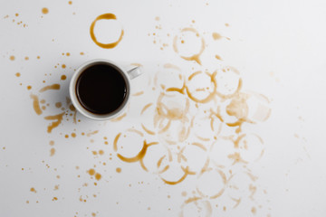 a Cup of black coffee on a coffee-filled white background top view. a place for a label