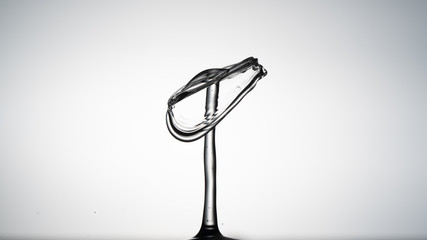 Close-up of a water drop falling on water surface