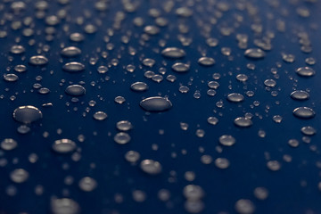 Water drops on a shiny surface, selective focus. Rain drops. Abstract background.