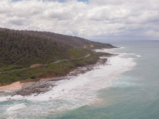 Beach view along Great Ocean Road. Beautiful ocean from road along coast, with beach. Blue ocean sea, white sand, mountain landscape. Travel, roadtrip, holiday, vacation, journey, paradise. Australia.